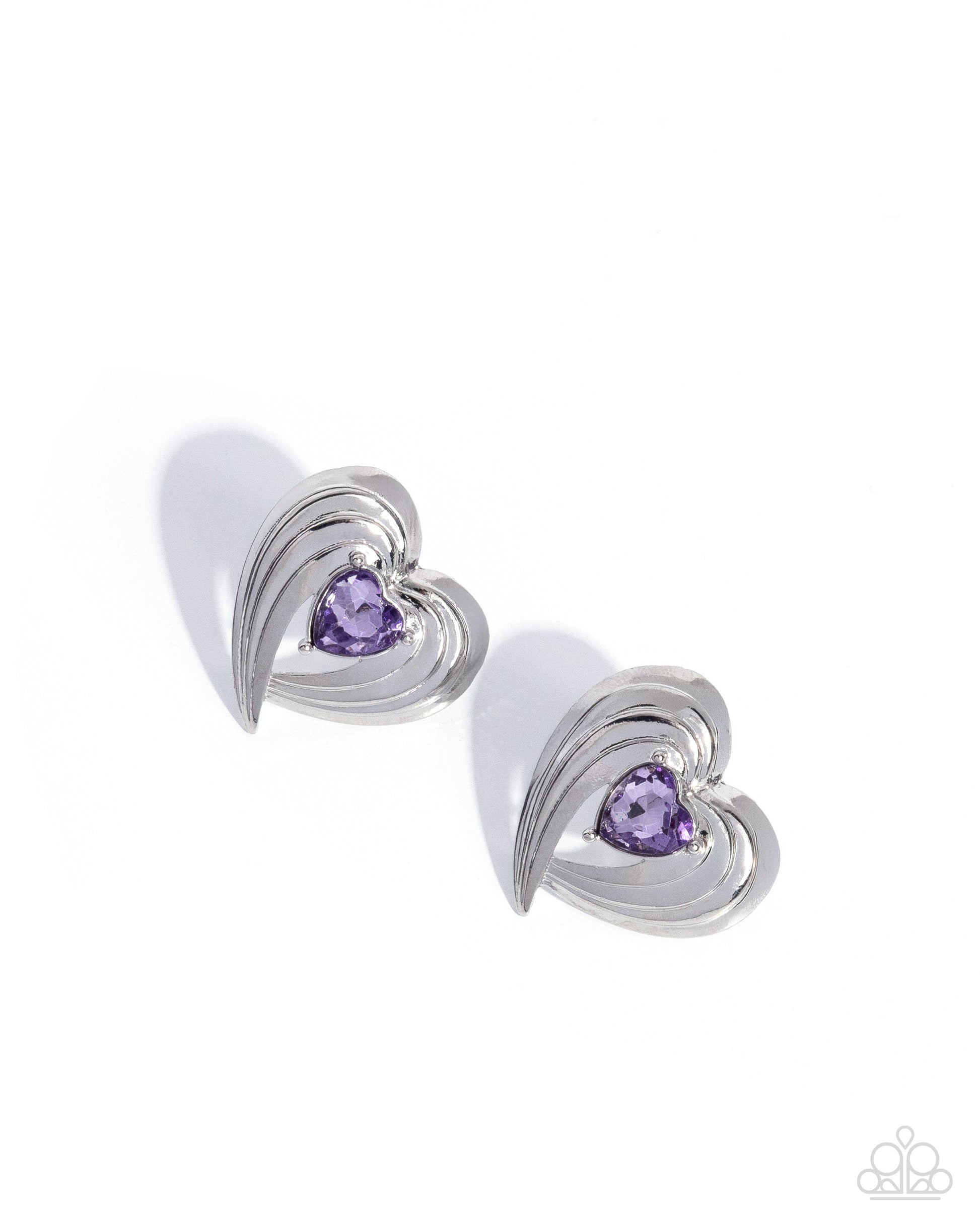 Pair of silver heart-shaped earrings with purple gemstones on a white background