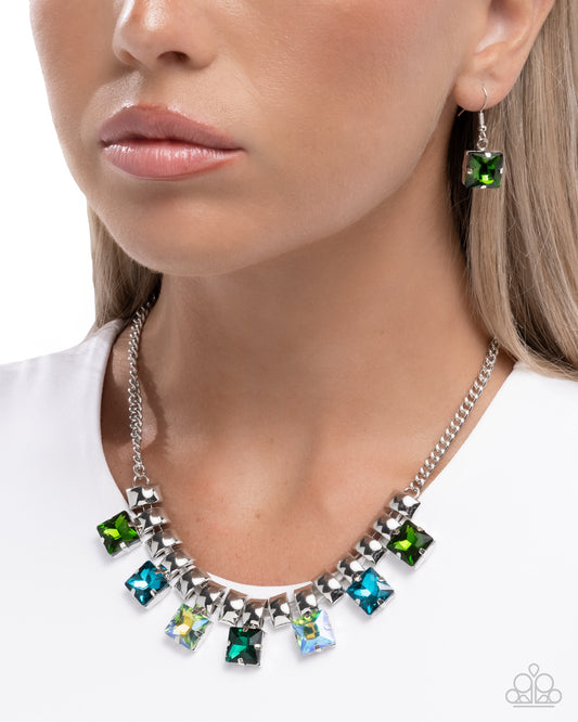 Necklace with green and blue gemstones worn by a model on a white background