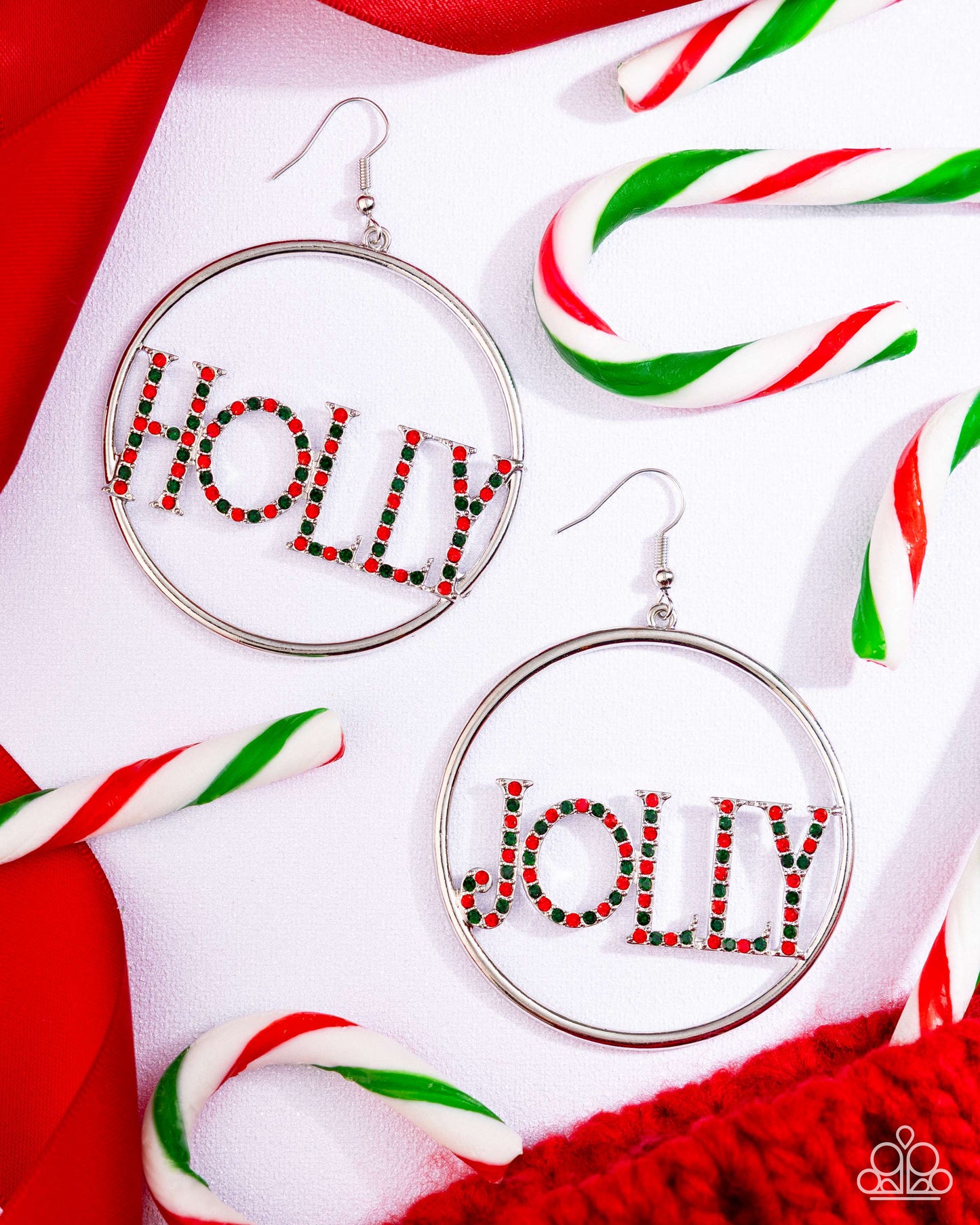 Hoop earrings with 'Holly' and 'Jolly' text on a festive background with candy canes.