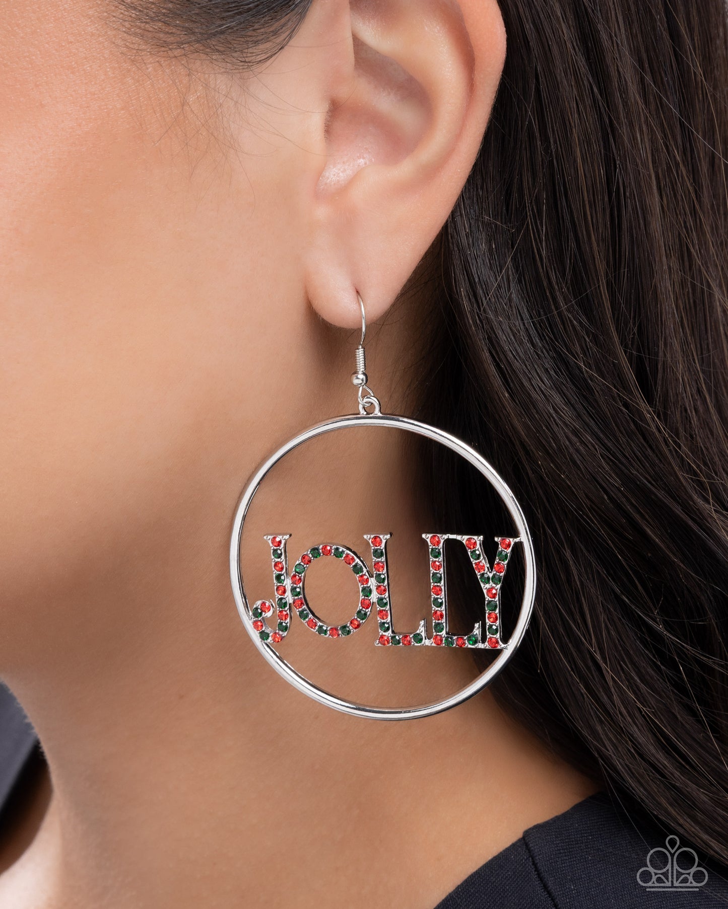 Silver hoop earring with 'JOLLY' text in colorful beads worn by a person.
