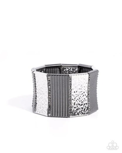 Silver hexagonal bracelet with textured design on a white background