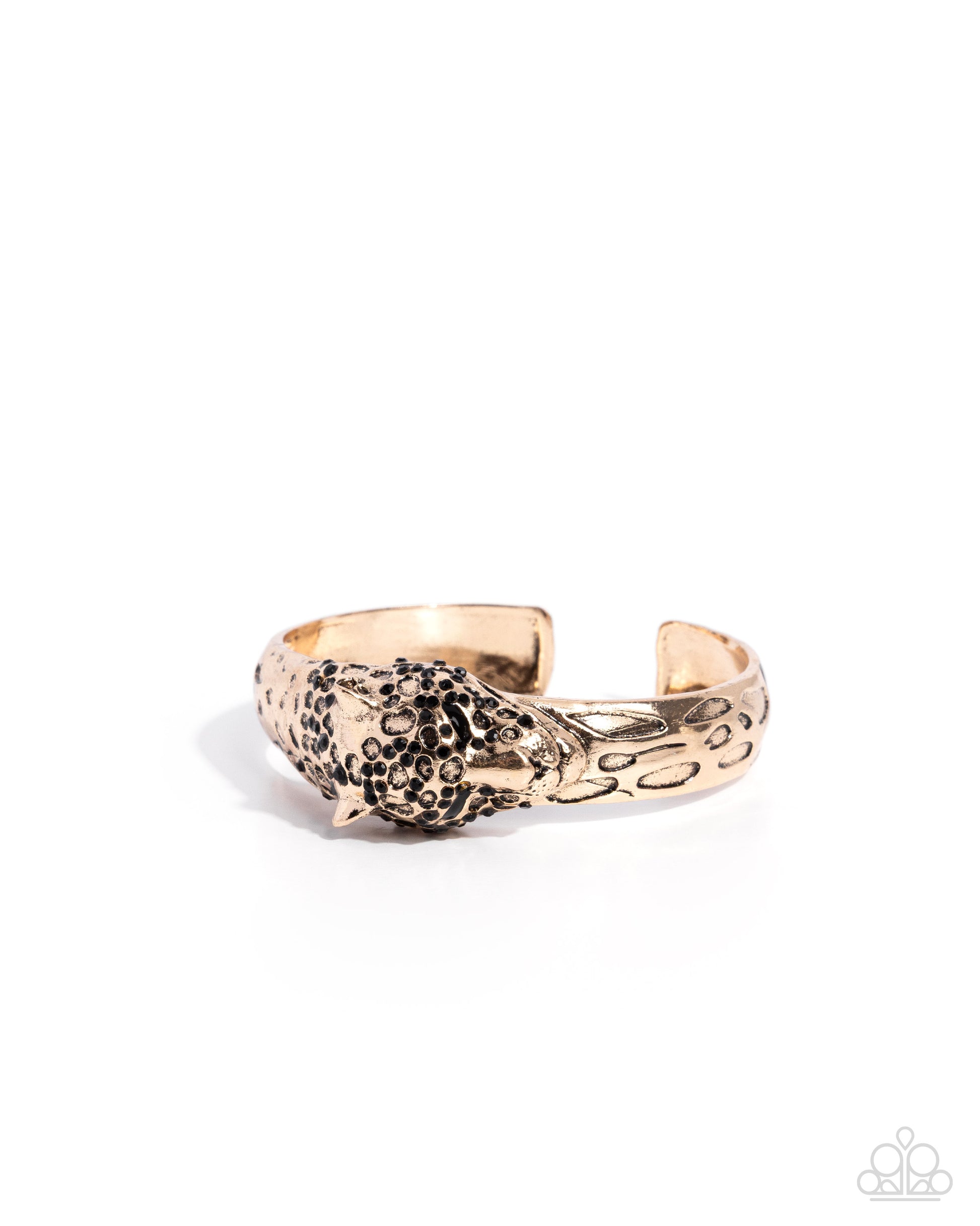 Gold and black patterned cuff bracelet on a white background