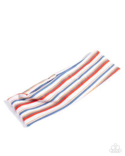 Striped towel with red, blue, and white colors on a white background