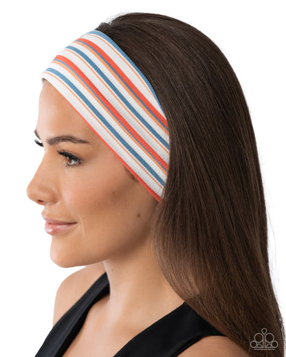 Woman wearing a striped headband on a white background