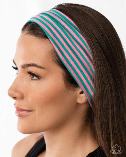 Woman wearing a green and pink striped headband on a white background