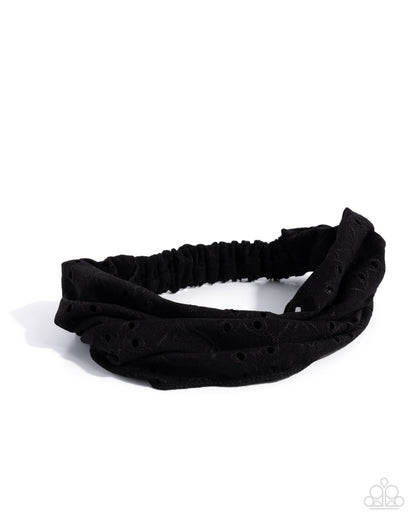 Black headband with textured pattern on a white background