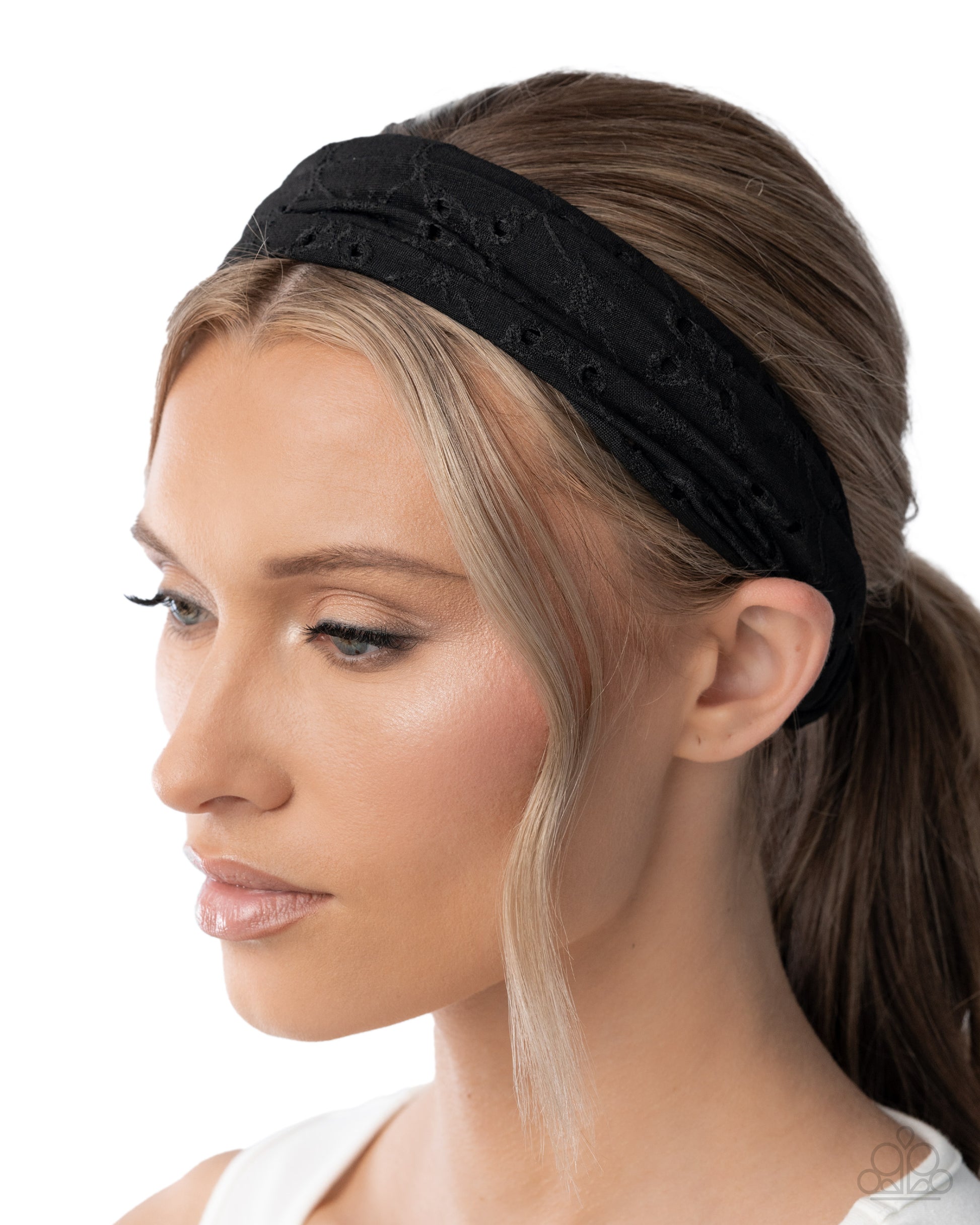 Woman wearing a black headband with a white background