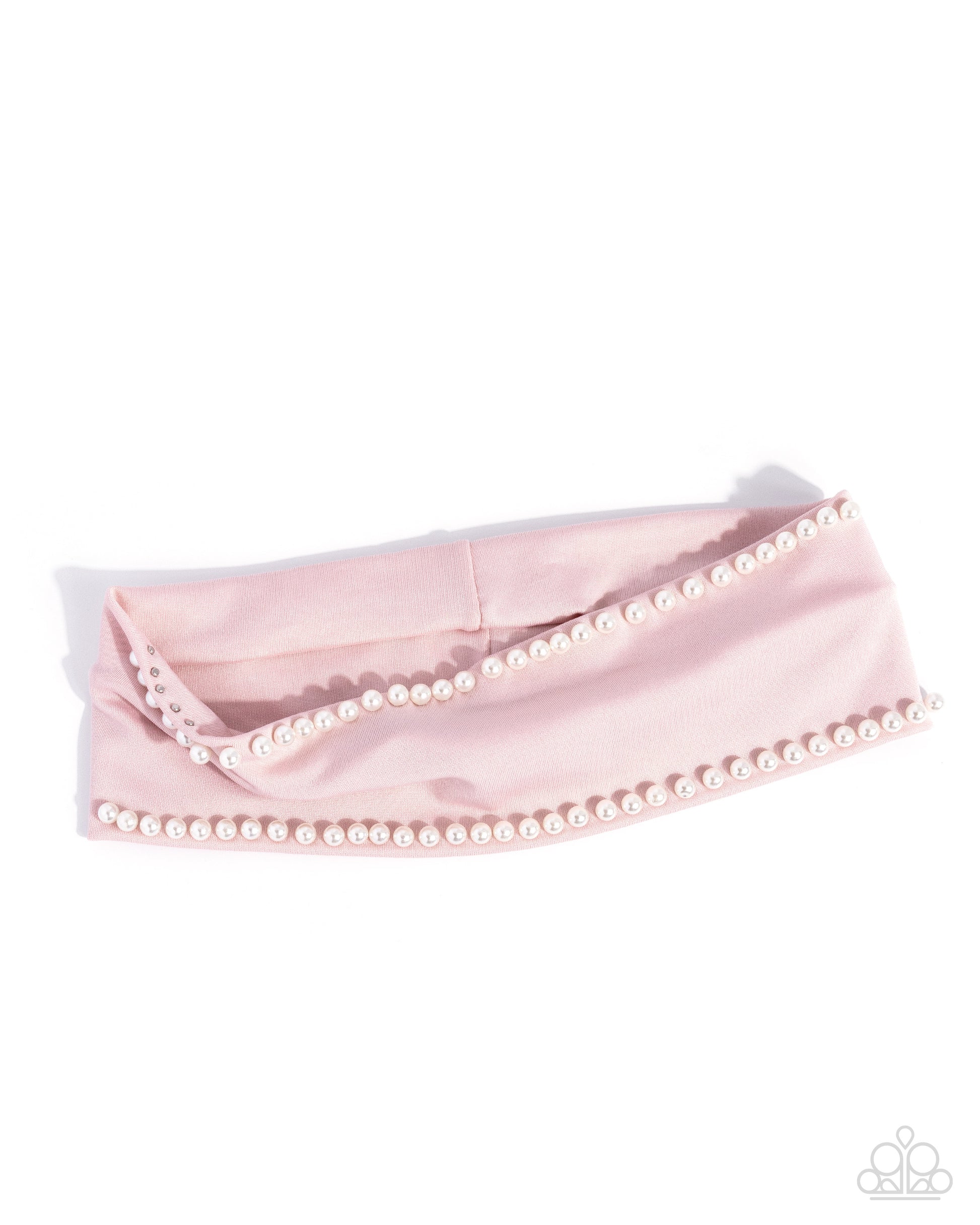 Pink headband with pearl embellishments on a white background