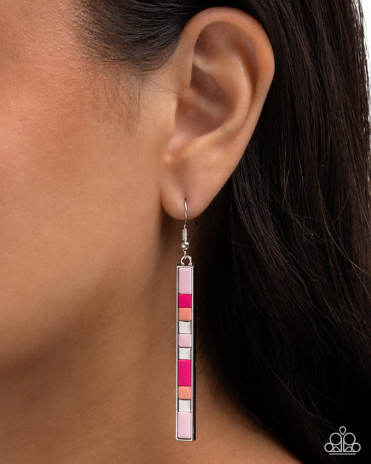 Earring with colorful square design worn on an ear