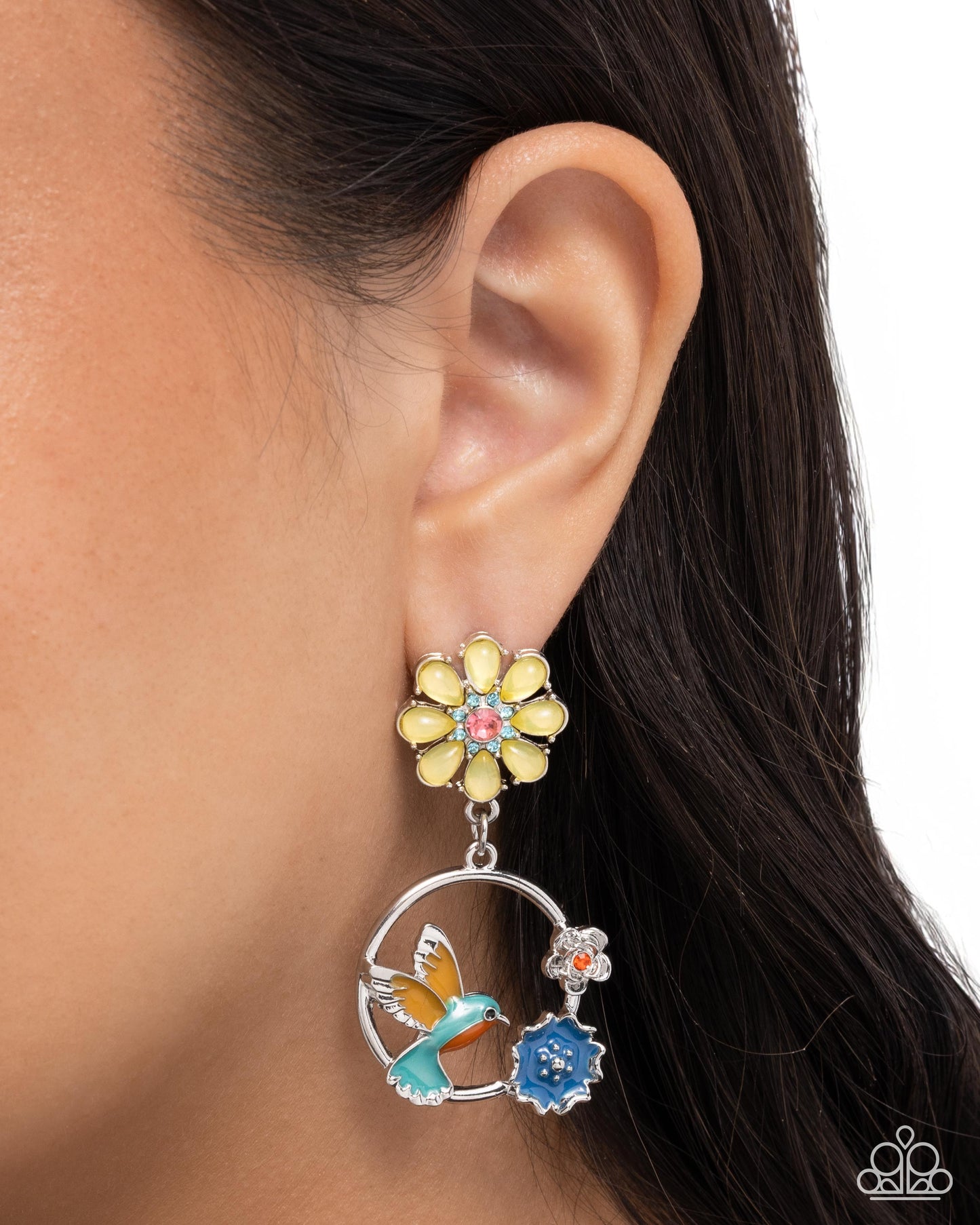 Earring with floral and bird design worn by a person
