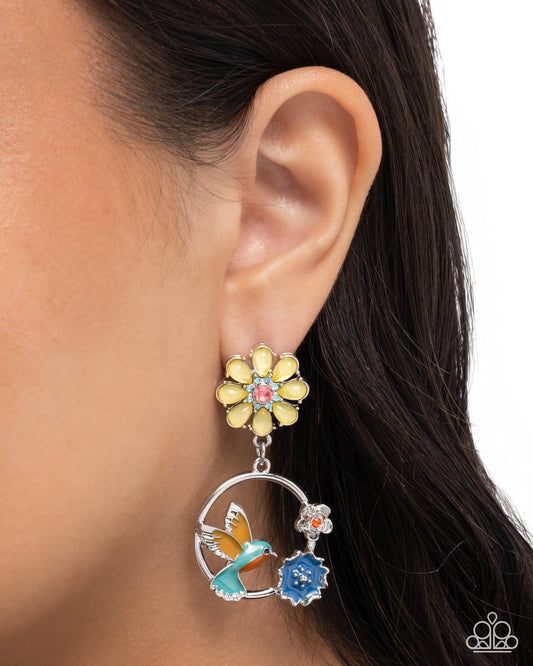 Earring with floral and bird design worn by a person