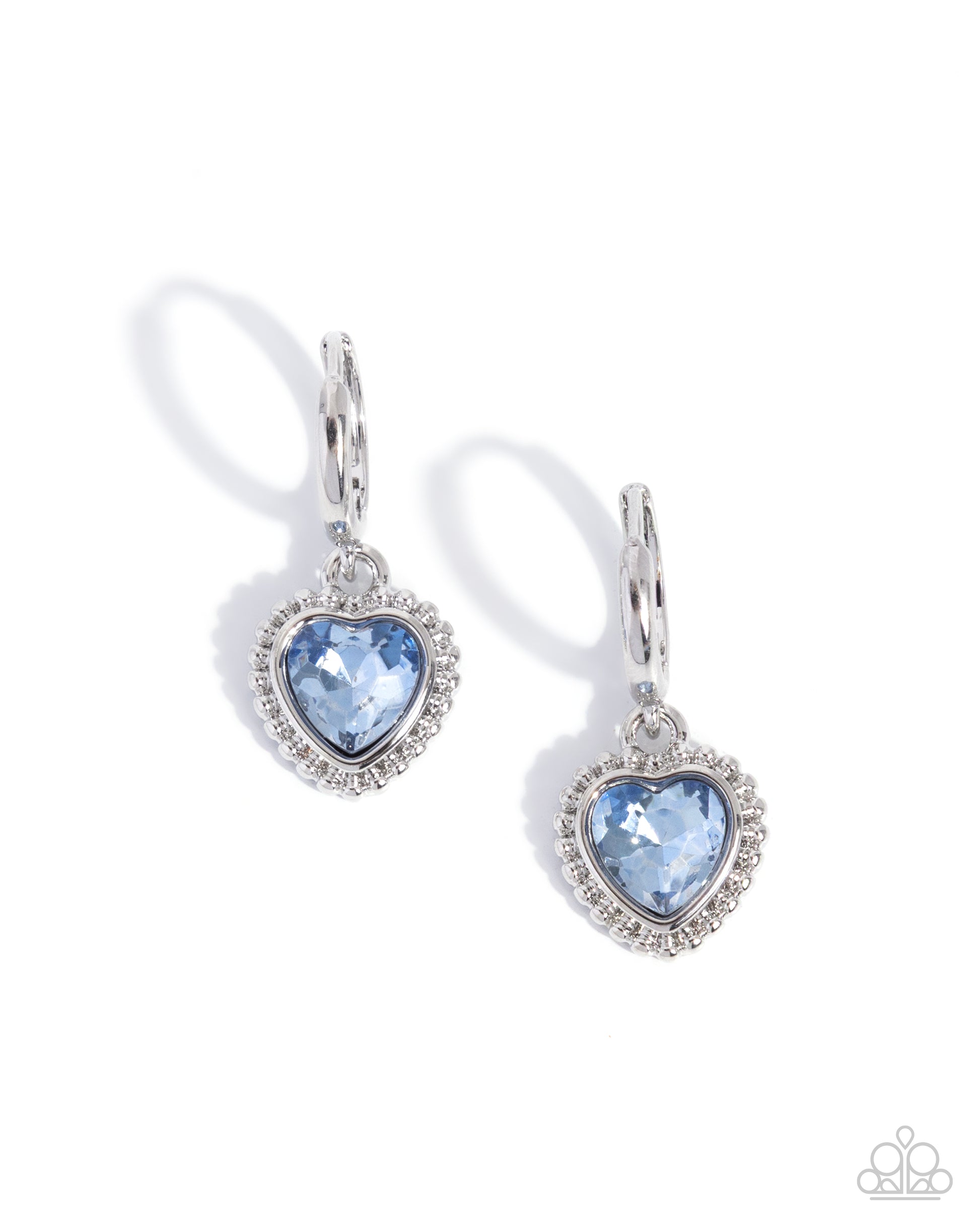 Heart-shaped blue gemstone earrings with silver frames on a white background
