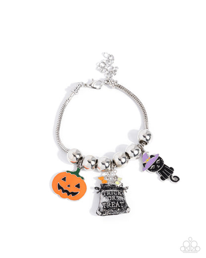 Silver bracelet with Halloween-themed charms on a white background