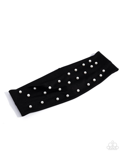 Black arm sleeve with pearl embellishments on a white background