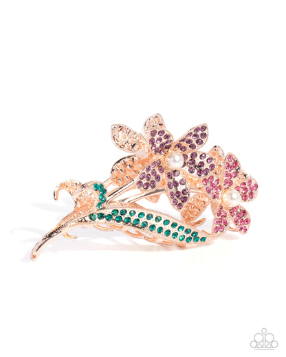 Decorative hair clip with floral design and colorful gemstones on a white background