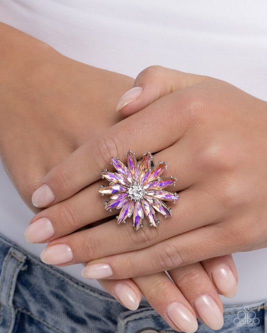 Close-up of a hand wearing a sparkling ring with a white background