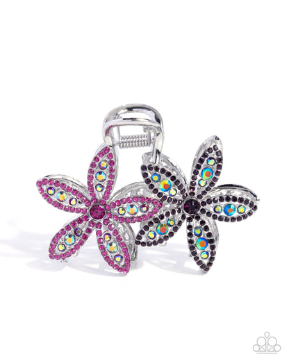 Flower-shaped hair clip with colorful gemstones on a white background
