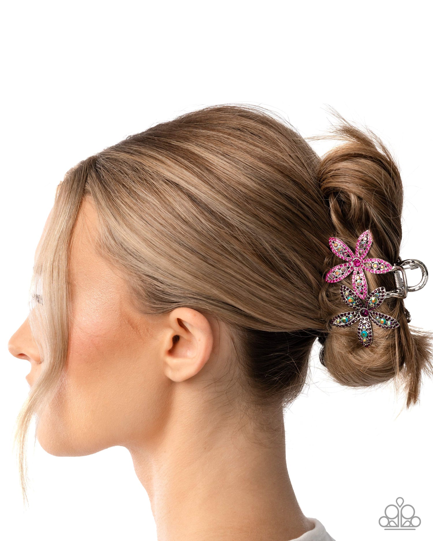 Woman with a bun wearing a decorative hair clip on a white background
