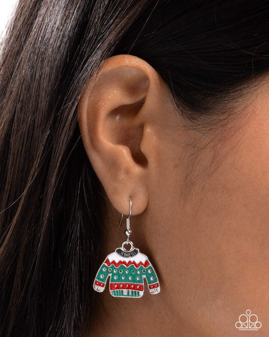 Earring shaped like a colorful sweater worn on an ear with dark hair.