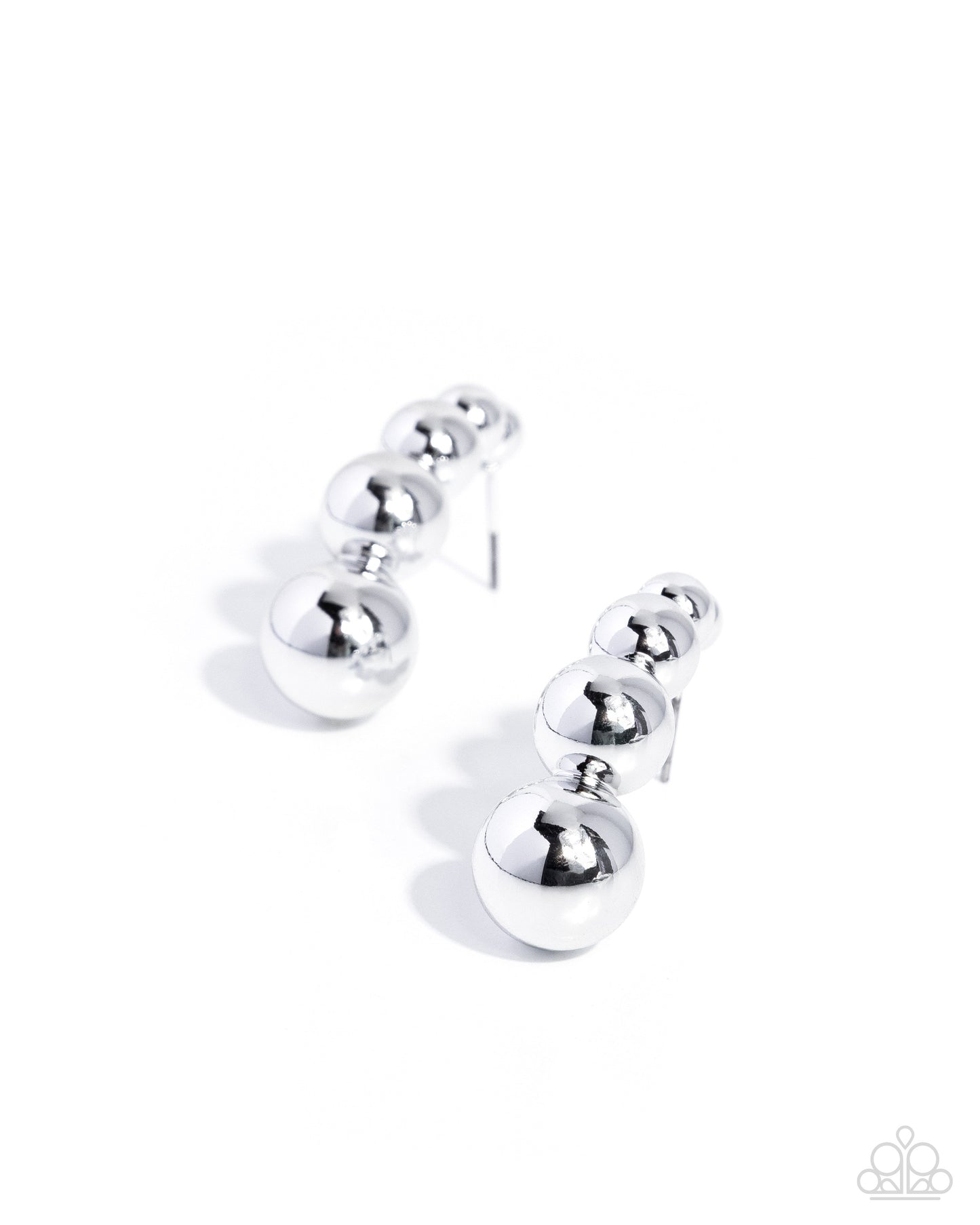 Silver earring with three spherical components on a white background