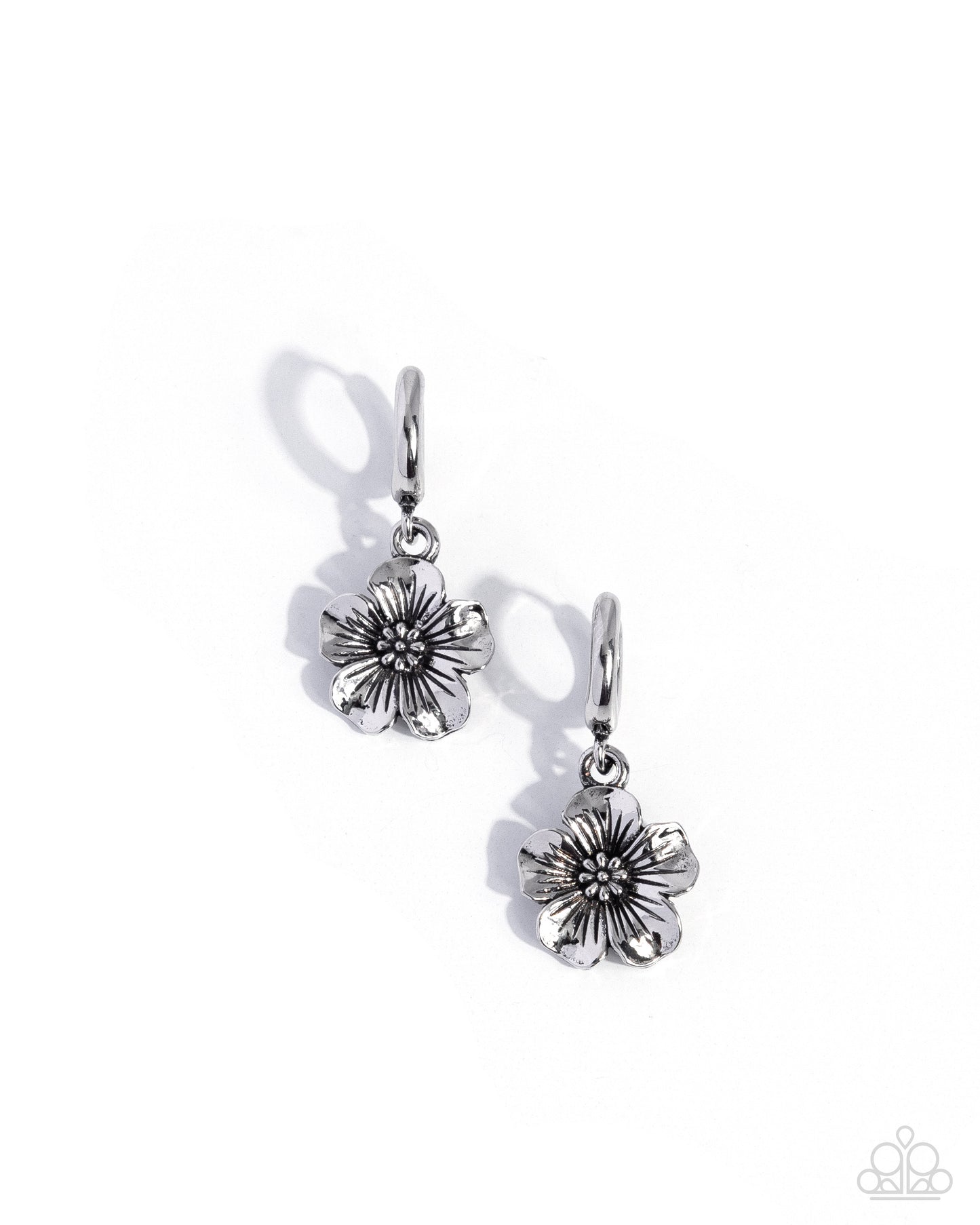 A pair of silver-toned dangle earrings featuring textured flower charms, displayed on a clean white background with soft shadows.