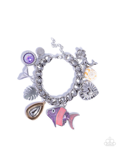 Silver charm bracelet with various charms on a white background