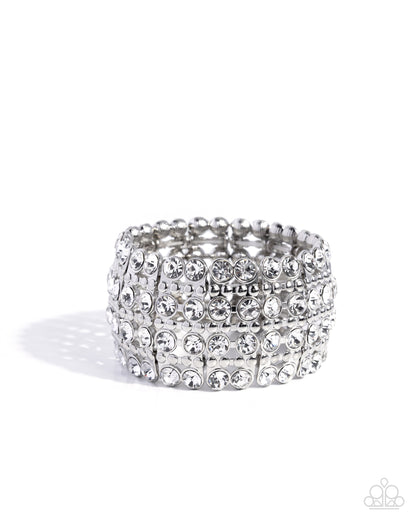 Silver ring with multiple rows of rhinestones on a white background