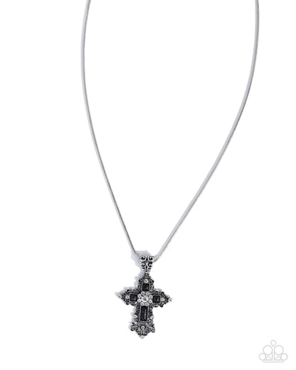 Silver cross necklace with black accents on a white background