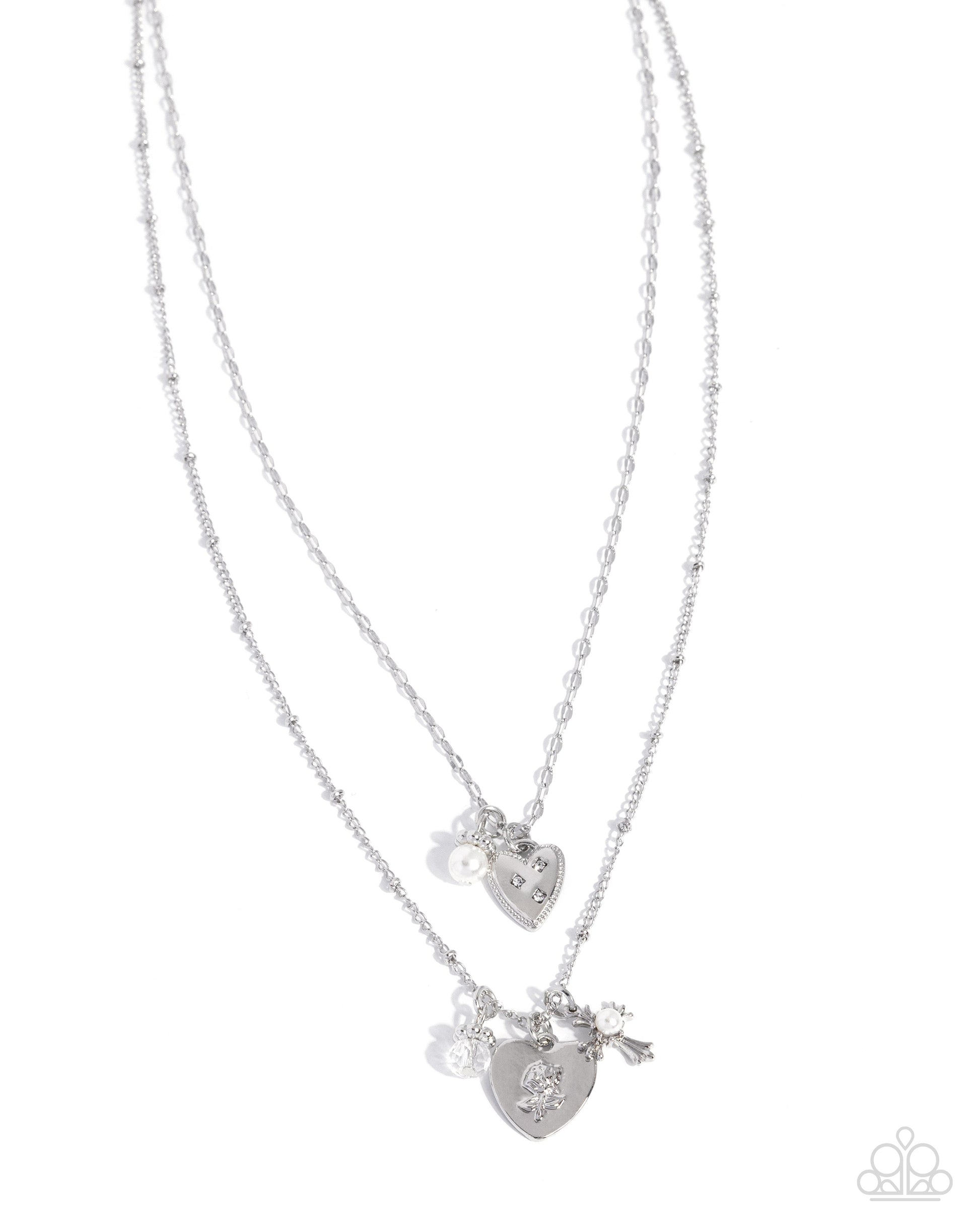 Two silver heart-shaped pendants on a white background