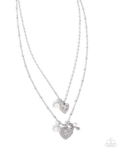 Two silver heart-shaped pendants on a white background