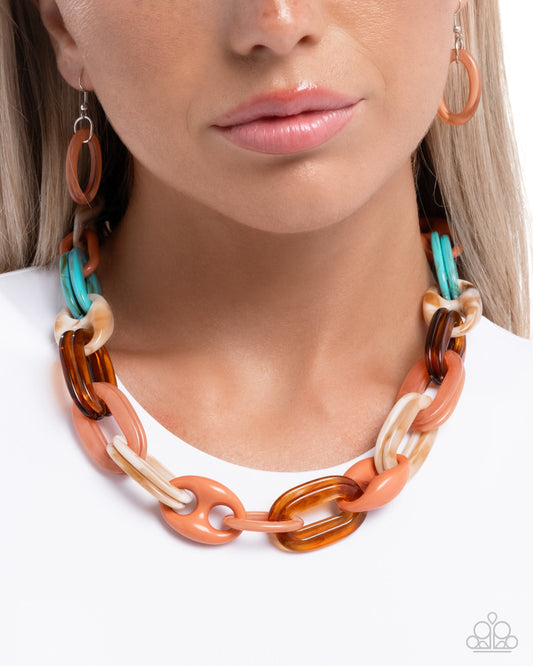 Necklace with multicolored links worn by a model on a white background