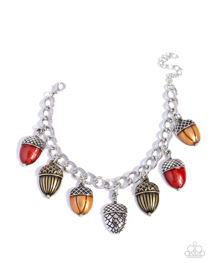 Bracelet with acorn charms on a white background
