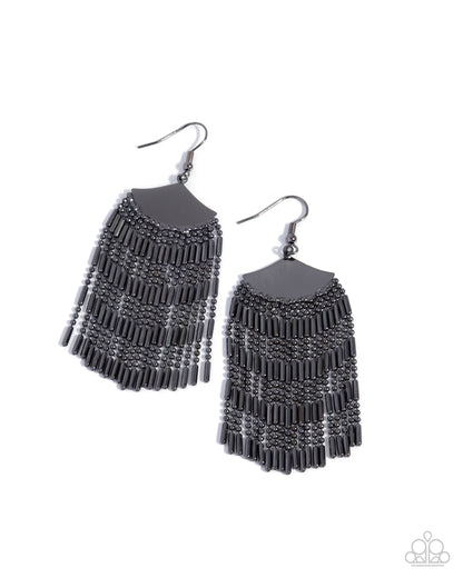 Pair of black fringe earrings on a white background