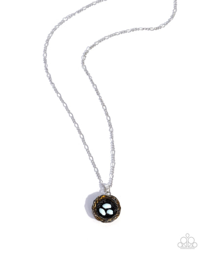 Necklace with a black and gold pendant on a white background
