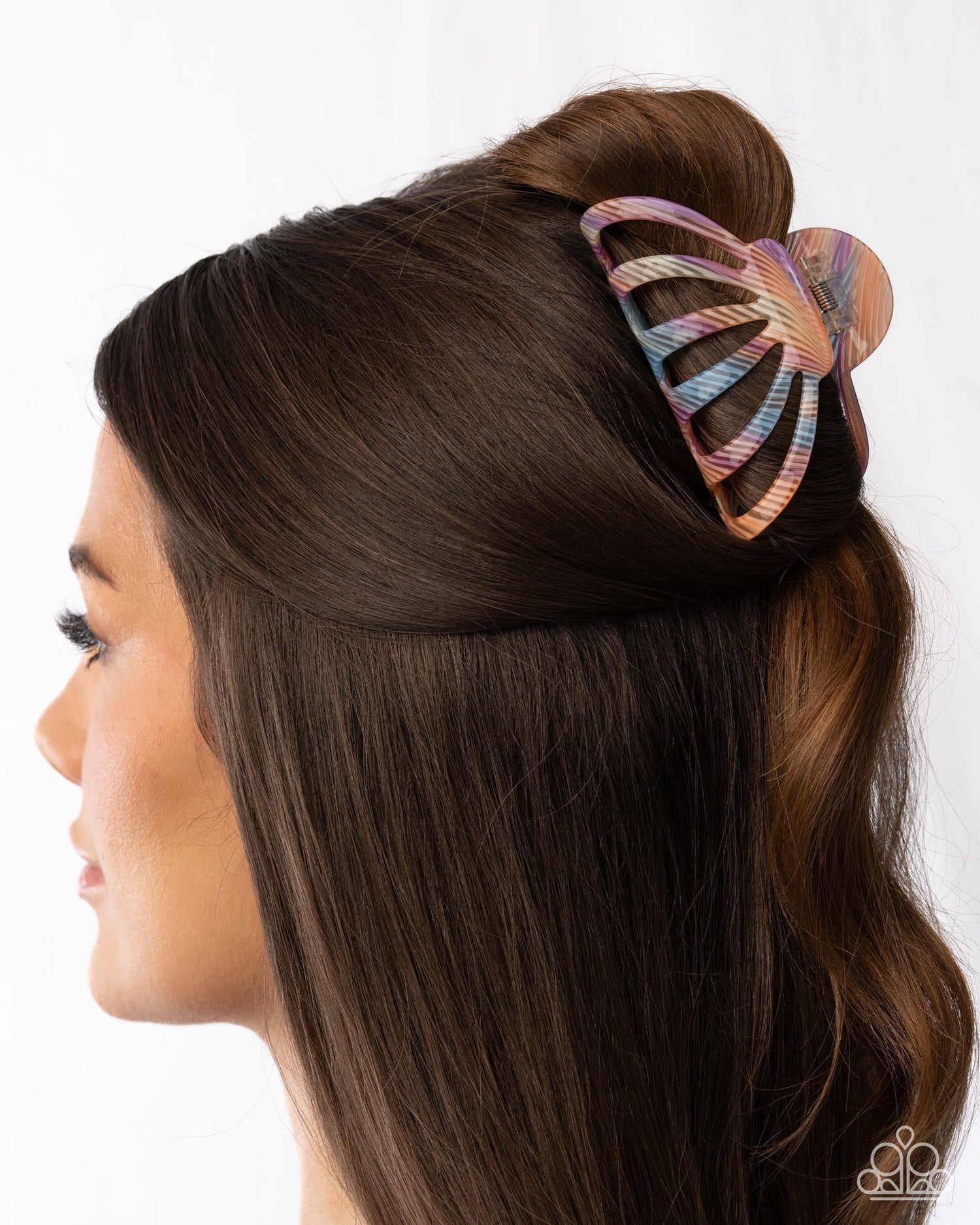 Butterfly hair clip in a woman's hair against a white background