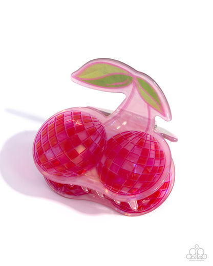Pink cherry-shaped lollipop with a green leaf on a white background