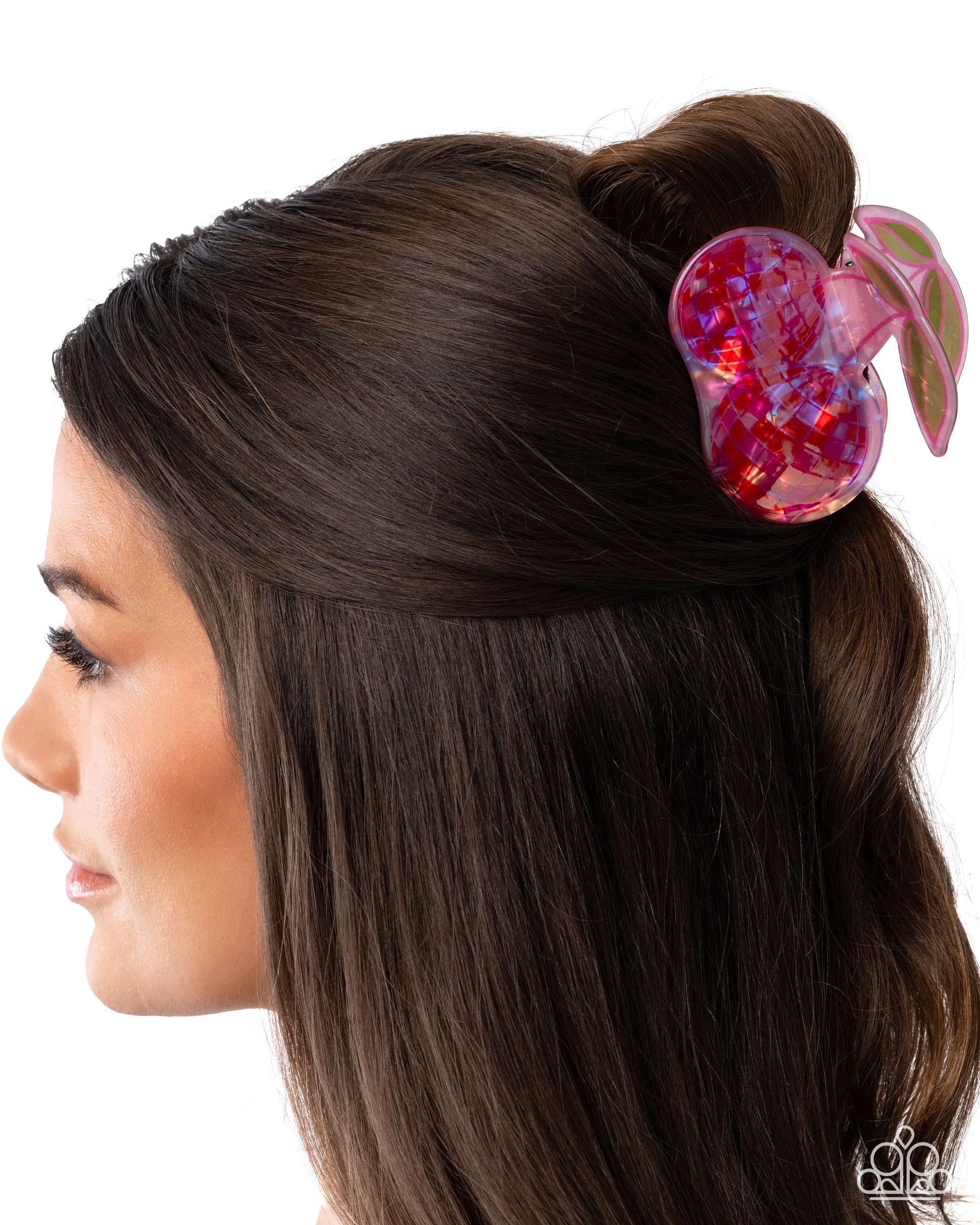 Woman with a pink butterfly hair clip in her hair on a white background
