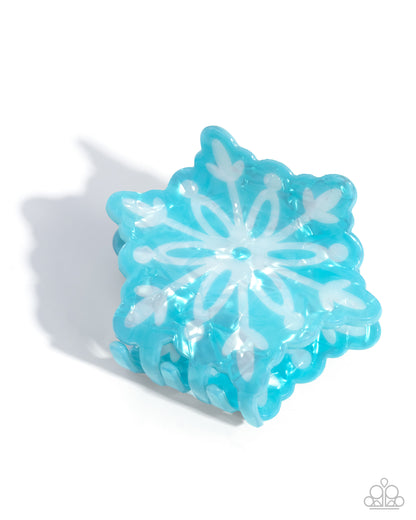 Blue snowflake-shaped object on a white background