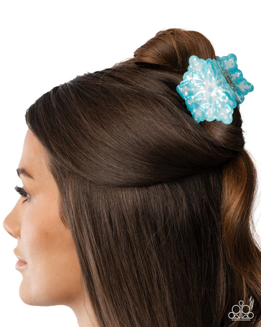 Blue hair clip in a person's hair on a white background