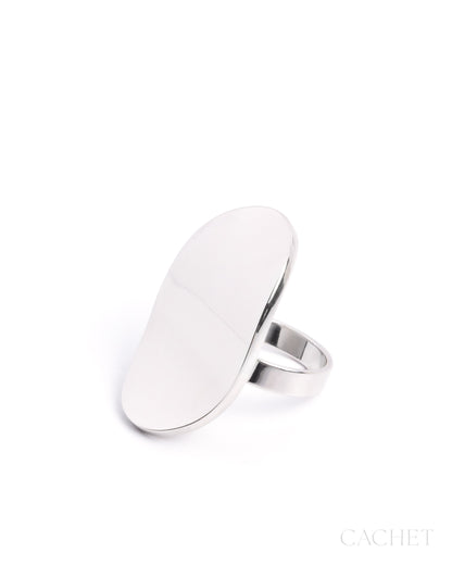 Silver ring with a flat, oval-shaped top on a white background