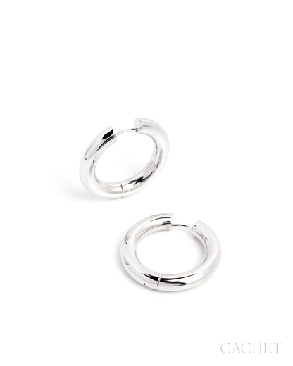Pair of silver hoop earrings on a white background with 'Cachet' branding.