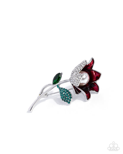 Decorative brooch with red flower, pearl, and green leaves on a white background