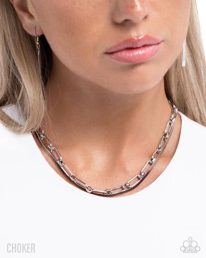 Silver chain choker necklace worn by a model on a white background