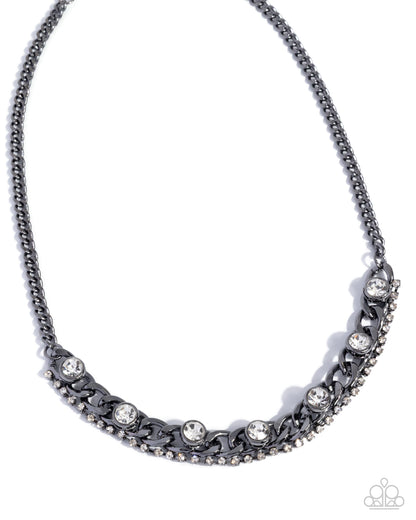 Silver necklace with floral and leaf designs on a white background