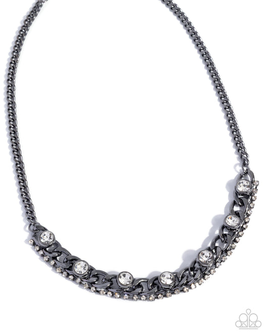 Silver necklace with floral and leaf designs on a white background