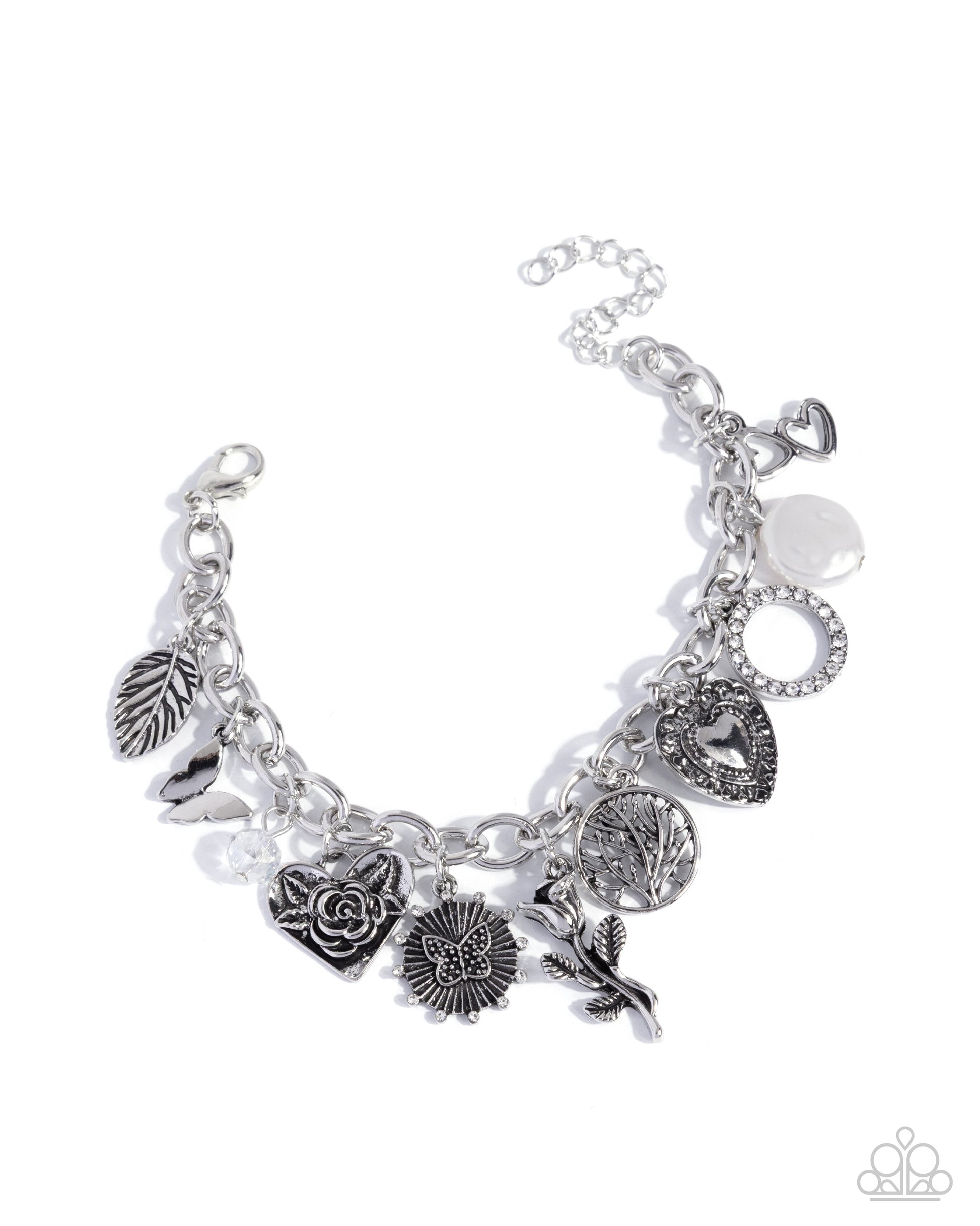 Silver charm bracelet with various charms on a white background