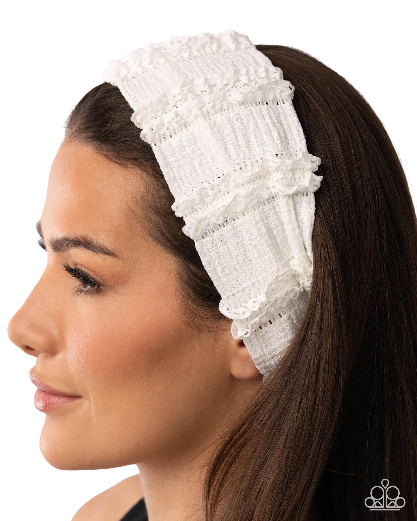 Woman wearing a white lace headband with a plain background