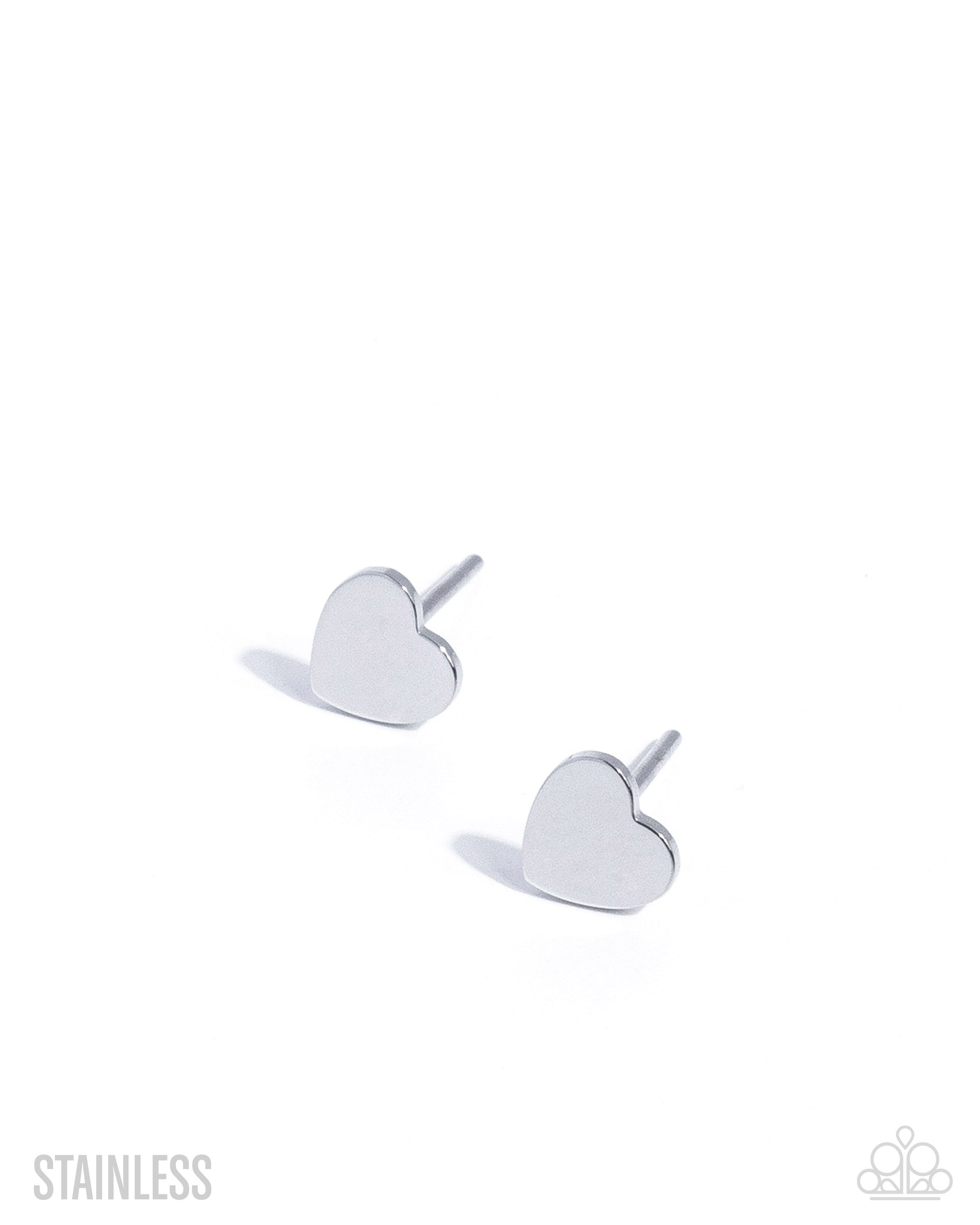 Heart-shaped silver earrings on a white background