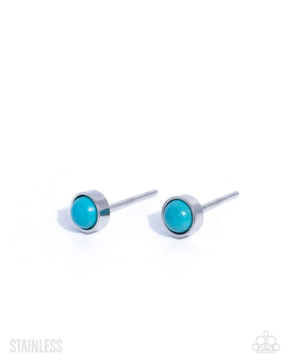 Turquoise stud earrings with silver posts on a white background