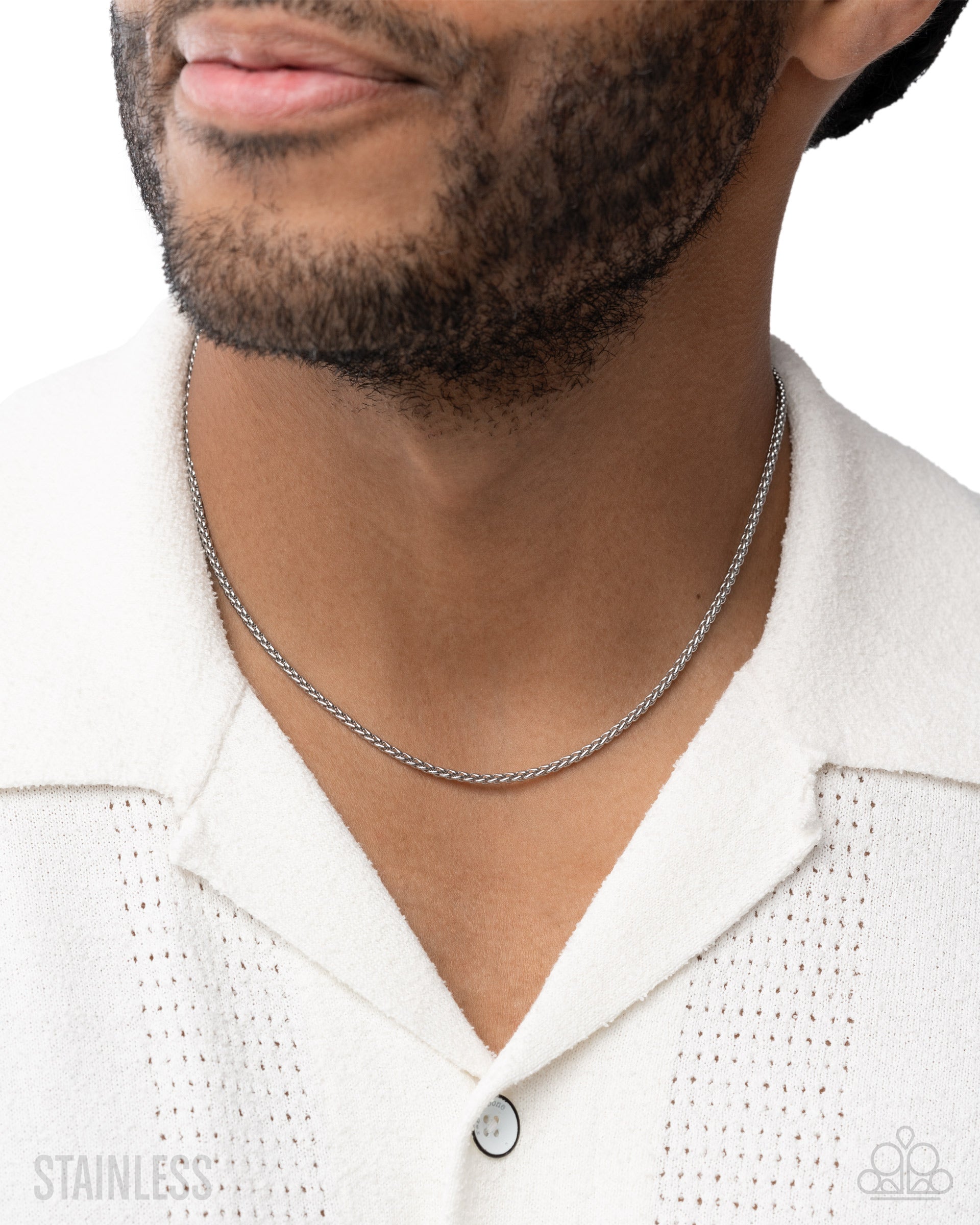 Man wearing a silver chain necklace on a white background